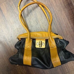 B. Makowsky Rockefeller shoulder bag crafted from black and tan glove leather